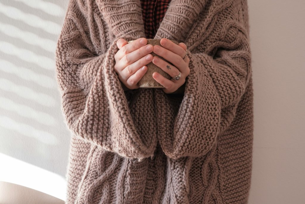 Cosy cardigan and herbal tea for winter wellness