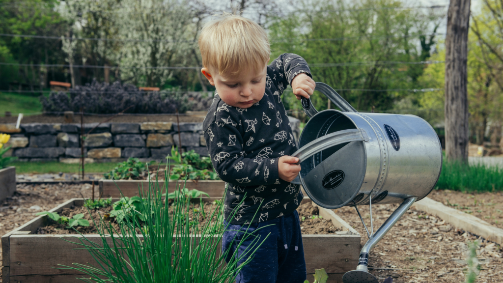 Greener Gardening with toddler watering the beds