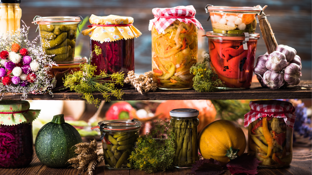 Preserved Autumn Vegetables in Jars on Wooden Shelves