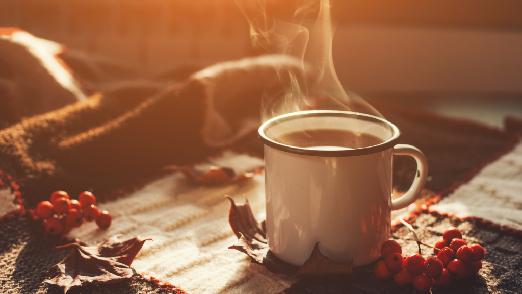 A warm, steaming cup of tea on a wooden table, symbolising the calm and simplicity of slow living.