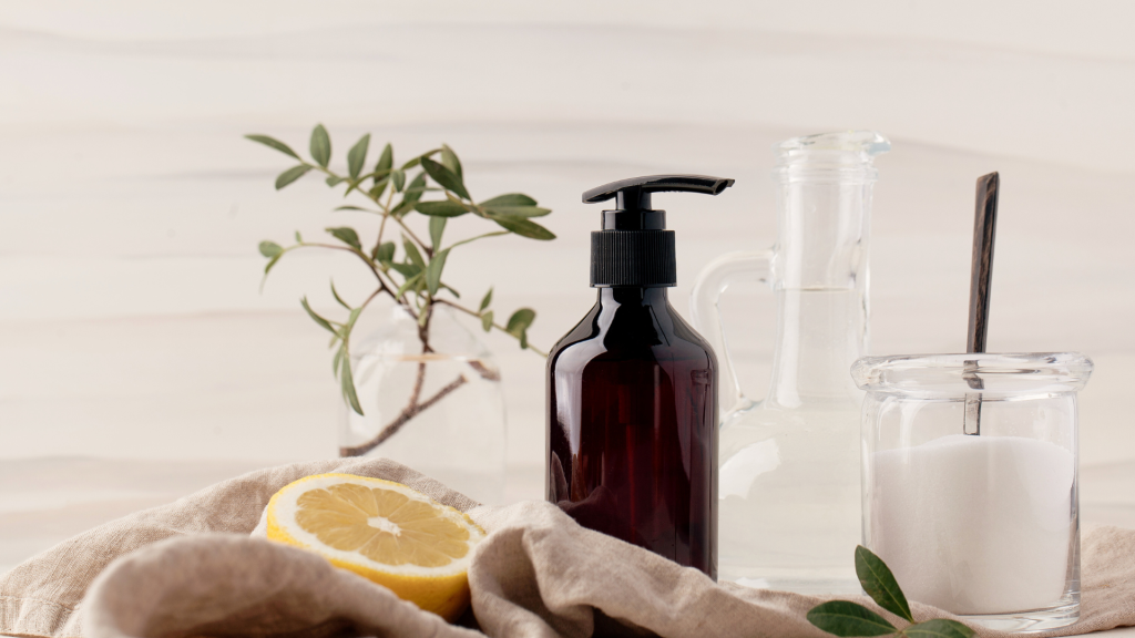 A set of reusable bottles for cleaning products, filled with natural and eco-friendly solutions. These sustainable alternatives highlight the zero-waste cleaning practices promoted in the blog and at HOH.