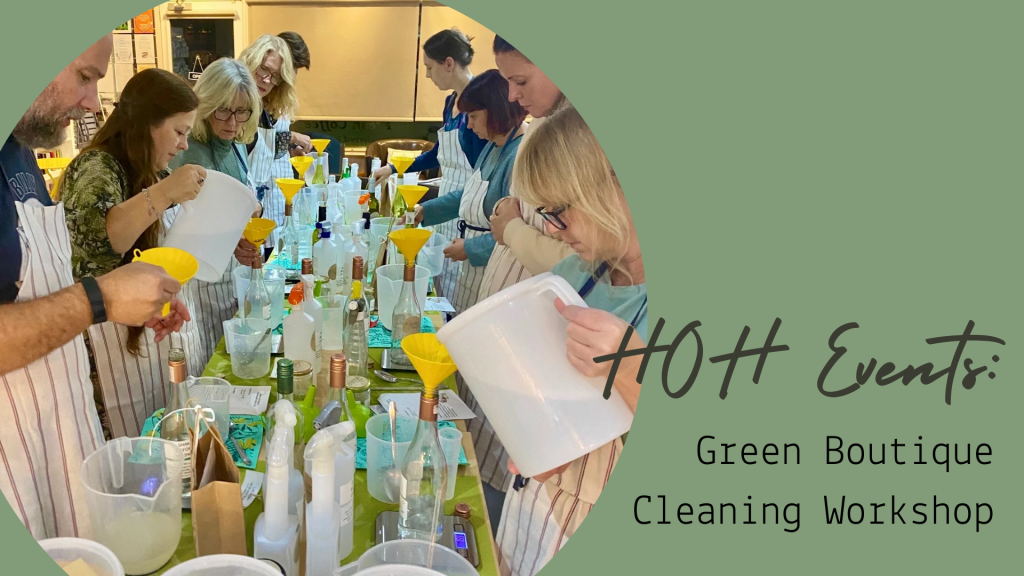 A group of people at a workshop mixing natural, eco-friendly cleaning products in reusable bottles, led by Jo from The Green Boutique.