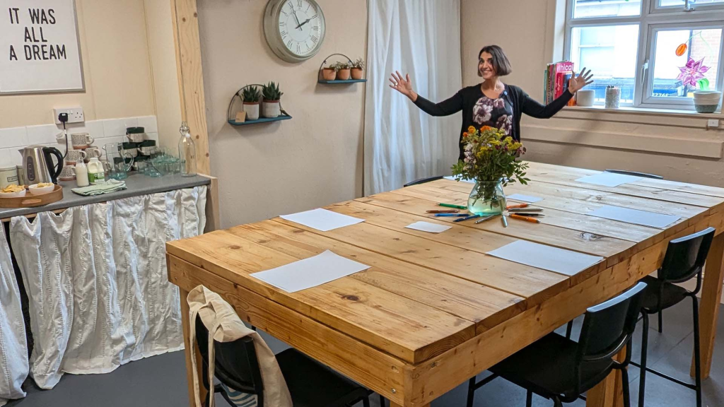 A bright, welcoming event space at Harriet’s of Hove, with a large wooden table, seating, and natural light, ready for a workshop or group gathering.